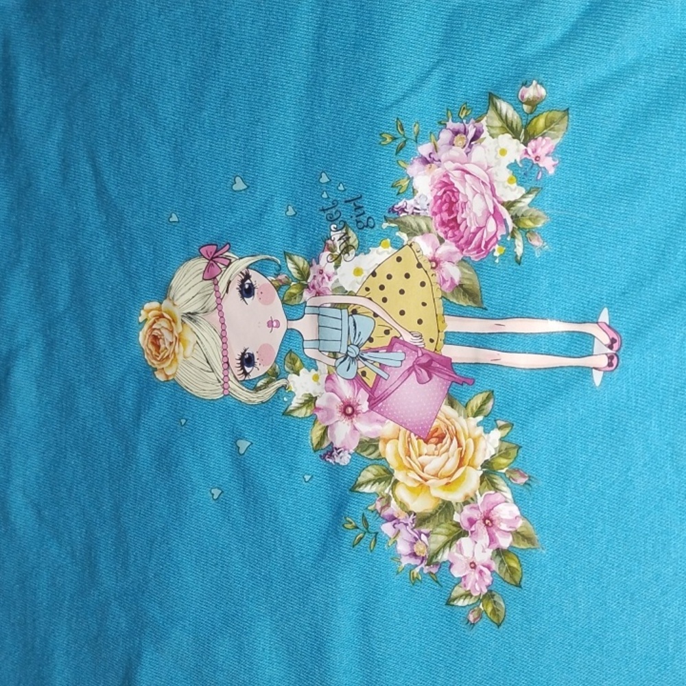 Blue Graphic Tee with Floral and Doll Design